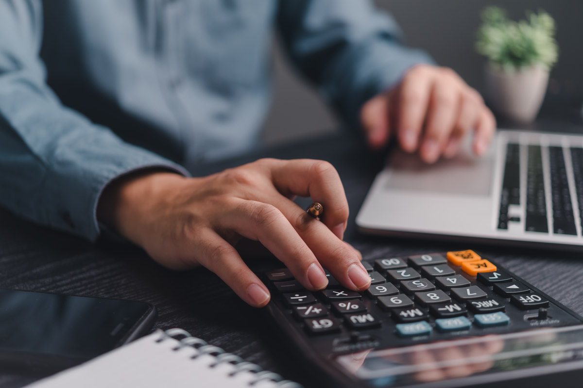 Close Up einer Hand auf einem Taschenrechner - Wir kalkulieren nach - 1516 Finance - Finanzpartner für B2B